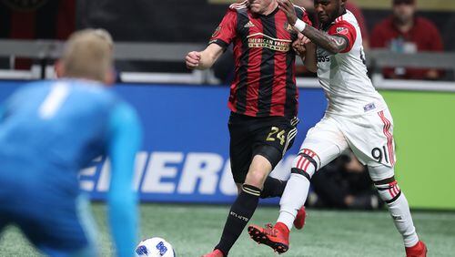 March 11, 2018 Atlanta: Atlanta United midfielder Julian Gressel battles D.C. United Oniel Fisher as he takes a shot on goal in a MLS soccer game on Sunday, March 11, 2018, in Atlanta.    Curtis Compton/ccompton@ajc.com