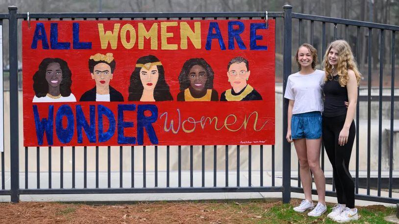 Dunwoody High School students Hannah Hazen and Amelia Mutert pose with their mural at Brook Run Skate Park. (Photo Courtesy of Paul Ward)
