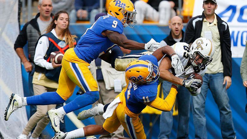 PITTSBURGH, PA - OCTOBER 08:  Brad Stewart #83 of the Georgia Tech Yellow Jackets pulls in the pass against Dane Jackson #11 and Jordan Whitehead #9 of the Pittsburgh Panthers  in the second half on October 8, 2016 at Heinz Field in Pittsburgh, Pennsylvania.  (Photo by Justin K. Aller/Getty Images)