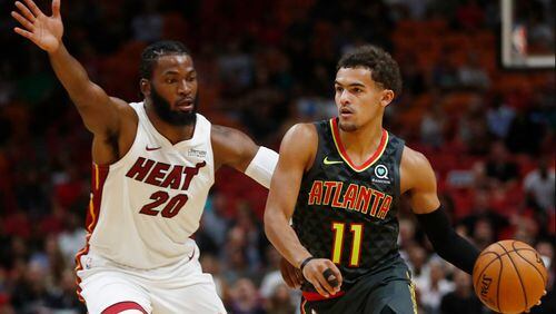 Trae Young drives against Miami's Justice Winslow during Monday's game. (AP Photo/Brynn Anderson)