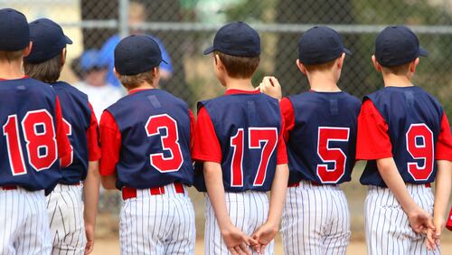 Little League players standing in line before a game.