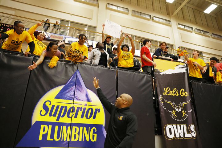Kennesaw State Owls head coach Amir Abdur-Rahim celebrates with fans after the 88-81 victory against the Liberty Flames at the Kennesaw State Convention Center on Thursday, Feb 16, 2023.
 Miguel Martinez / miguel.martinezjimenez@ajc.com