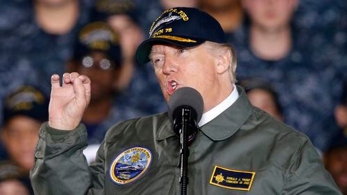 President Donald Trump gestures as he speaks to Navy and shipyard personnel aboard nuclear aircraft carrier Gerald R. Ford at Newport News Shipbuilding in Newport News, Va., Thursday, March 2, 2017. The ship which is still under construction is due to be delivered to the Navy later this year. (AP Photo/Steve Helber)