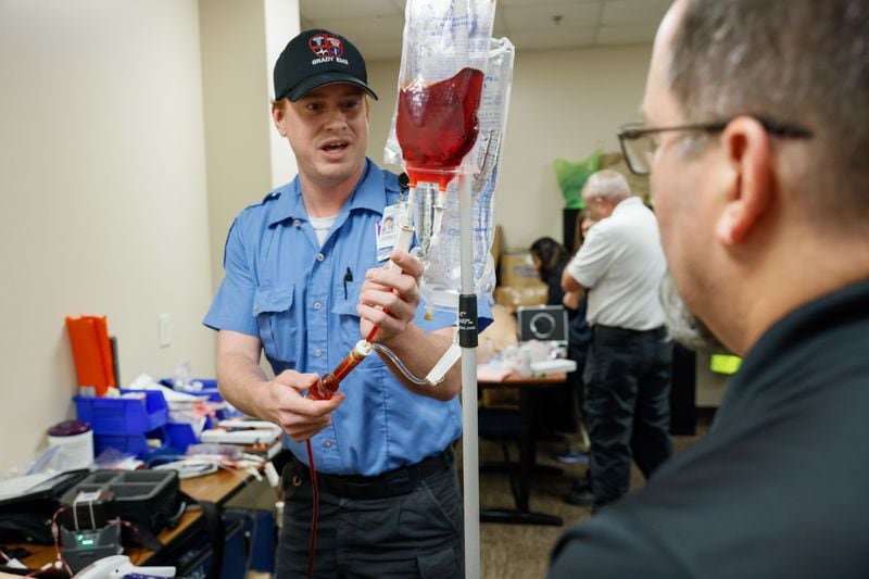Grady Memorial lead paramedic Robert Haeusler, left, explains to David Crosby from Life Flow Clinical Manager how to use their equipment for blood transfusion at Grady EMS headquarters. (Miguel Martinez /miguel.martinezjimenez@ajc.com)