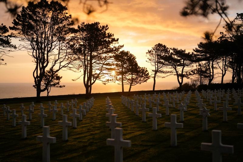 The sun rises on the US cemetery of Colleville-sur-Mer, Normandy, Wednesday, April 10, 2024. On D-Day, Charles Shay was a 19-year-old Native American army medic who was ready to give his life — and actually saved many. Now 99, he's spreading a message of peace with tireless dedication as he's about to take part in the 80th celebrations of the landings in Normandy that led to the liberation of France and Europe from Nazi Germany occupation. (AP Photo/Thibault Camus)