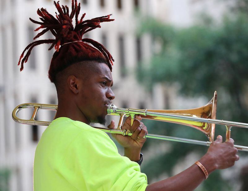October 16, 2019 Atlanta: Street performer Eryk D. Radical, 26, a legally blind Georgia State University student, plays his trombone on Peachtree Street at Andrew Young International Boulevard in Atlanta. Radical is suing Atlanta police, MARTA police and the Fulton County Sheriff’s office alleging repeated harassment while playing on street corners. Curtis Compton/ccompton@ajc.com