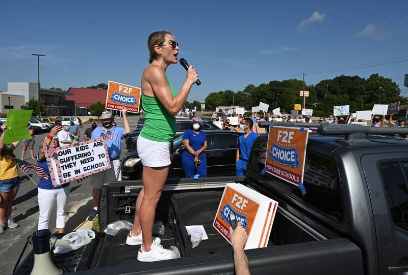 Amy Henry leads parents, students and community members during a rally to call on Superintendent Chris Ragsdale and the Cobb school board to offer in-person classes alongside virtual learning outside Cobb County Civic Center in Marietta on Saturday, August 1, 2020. (Photo: Hyosub Shin / Hyosub.Shin@ajc.com)