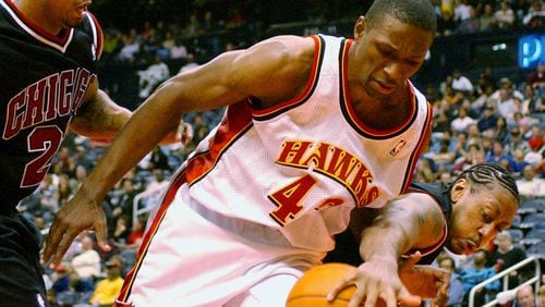 Atlanta Hawks' Theo Ratliff (42) battles Chicago Bulls' Donyell Marshall, right, and Marcus Fizer (21) for a loose ball during the fourth quarter Saturday, Nov. 2, 2002, in Atlanta. The Theo Ratliff Foundation is one of the partners for the 2018 Atlanta Peace Games.