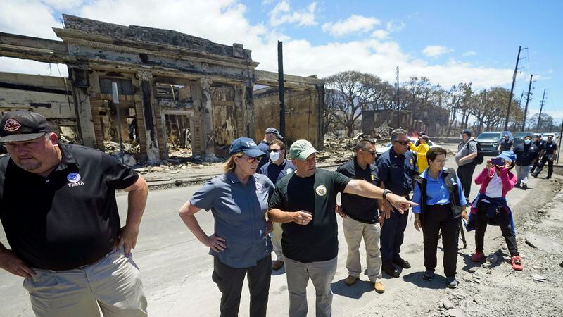 FILE - Hawaii Gov. Josh Green, center, points to damage as he speaks with Federal Emergency Management Agency Administrator Deanne Criswell during a tour of wildfire damage, Saturday, Aug. 12, 2023, in Lahaina, Hawaii. (AP Photo/Rick Bowmer, File)