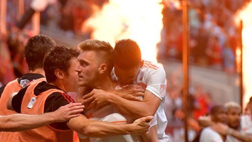 Atlanta United defender Julian Gressel (24) is congratulated by Atlanta United midfielder Ezequiel Barco (8) after Julian Gressel (24) scored a goal assisted by Leandro Gonzalez (5) during the second half in a MLS soccer match Saturday, April 27, 2019, at Mercedes-Benz Stadium in Atlanta.
