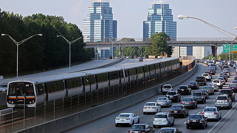 A MARTA train makes its way past Ga. 400 traffic in North Fulton. The Roswell City Council has asked the Legislature to authorize and fund a study of transit needs for metro Atlanta. AJC file photo