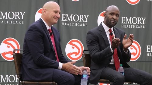 Atlanta Hawks general manager Travis Schlenk (left) introduces Lloyd Pierce as the 13th full-time coach in the Atlanta history of the NBA basketball franchise on May 14, 2018, in Atlanta. Curtis Compton/ccompton@ajc.com