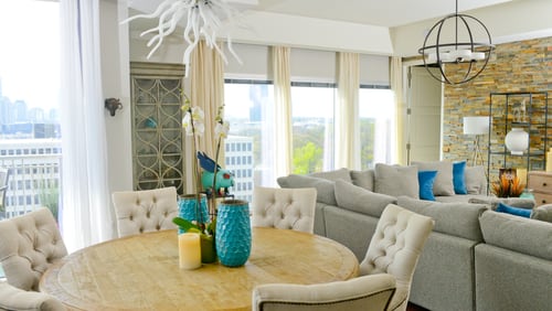 Jeffrey Taylor Johnson's Atlanta dining room serves up dinner and a spectacular view whenever guests gather. The 1,834-square-foot high-rise condo has an open floor plan, which meant Johnson's furnishings needed a cohesive style. The round table and six chairs, all from RH, are consistent with the transitional interior design throughout the unit.