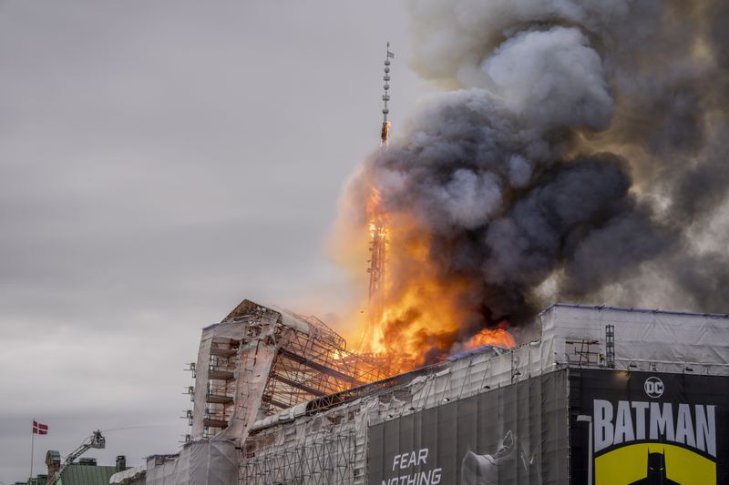 Fire rages from the dragon spire of the Stock Exchange in Copenhagen, Denmark, Tuesday, April 16, 2024. A fire raged through one of Copenhagen’s oldest buildings on Tuesday, causing the collapse of the iconic spire of the 17th-century Old Stock Exchange as passersby rushed to help emergency services save priceless paintings and other valuables. (Ida Marie Odgaard/Ritzau Scanpix via AP)
