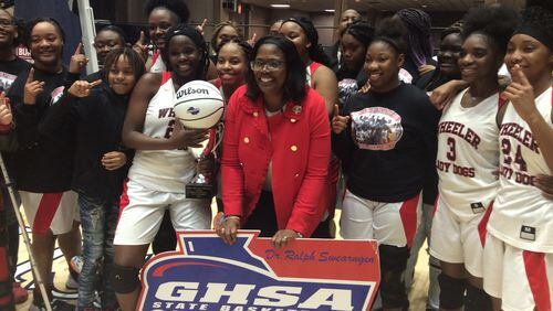 Coach Angelia Wright and the Wheeler County players celebrate the first girls basketball championship in school history on March 4, 2020, at the Macon Centreplex.