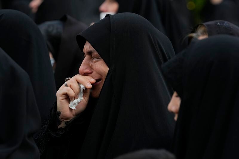 A woman weeps during a mourning ceremony for Iranian President Ebrahim Raisi at Vali-e-Asr square in downtown Tehran, Iran, Monday, May 20, 2024. President Raisi and the country's foreign minister were found dead Monday hours after their helicopter crashed in fog, leaving the Islamic Republic without two key leaders as extraordinary tensions grip the wider Middle East. (AP Photo/Vahid Salemi)