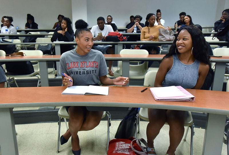 Kendall Youngblood, left, shares a smile with classmate Asia Mone't Johnson-Clark in an economics class at Clark Atlanta University on Tuesday, August 29, 2017. (HYOSUB SHIN / HSHIN@AJC.COM)