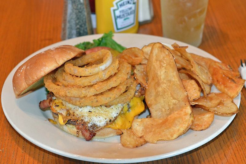 Lucky's Undertaker, a 7 ounce burger topped with applewood smoked bacon, two slices of American cheese, fried egg, fried onion straws at Lucky's Burger & Brew. / Handout photo