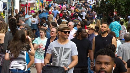 A large crowd walks past the food and artist booths during the 82nd Annual Atlanta Dogwood Festival in Piedmont Park. STEVE SCHAEFER / SPECIAL TO THE AJC
