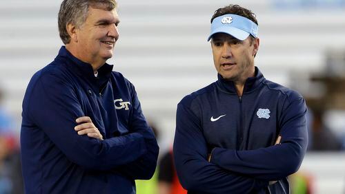 Georgia Tech coach Paul Johnson, left, and North Carolina coach Larry Fedora talk prior to an NCAA college football game in Chapel Hill, N.C., Saturday, Oct. 18, 2014. (AP Photo/Gerry Broome)