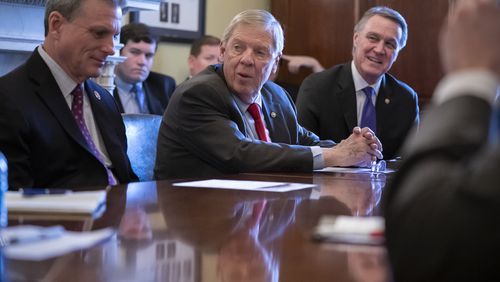 U.S. Sen. Johnny Isakson, R-Ga., is flanked by U.S. Rep. Buddy Carter R-Pooler, left, and U.S. Sen. David Perdue, R-Ga. All three have expressed their opposition to the impeachment inquiry against President Donald Trump. (AP Photo/J. Scott Applewhite)