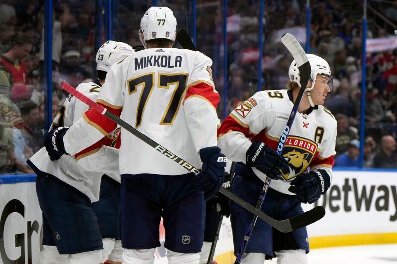 Florida Panthers left wing Matthew Tkachuk (19) celebrates his goal against the Tampa Bay Lightning with defenseman Niko Mikkola (77) and center Carter Verhaeghe (23) during the first period in Game 3 of an NHL hockey Stanley Cup first-round playoff series, Thursday, April 25, 2024, in Tampa, Fla. (AP Photo/Chris O'Meara)