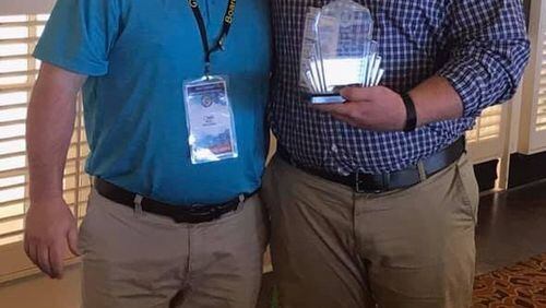 The Building Officials Association of Georgia recently honored City of Woodstock Senior Building Inspector Jake Hill with the 2019 Georgia Inspector of the Year Award. Pictured: (left) Josh Roth, President of the Building Officials Association of Georgia, and (right) Jake Hill, Senior Building Inspector of City of Woodstock.