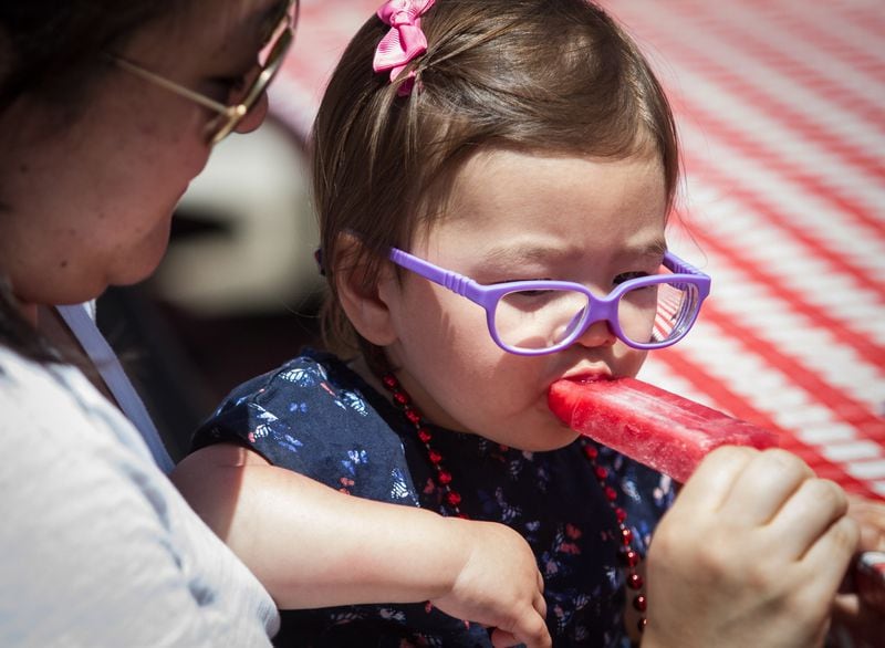 Katie Sobeck gives her daughter Garett a bite of her frozen treat during the Spring Jonquil Festival in Smyrna on  Saturday, April 28, 2018. 