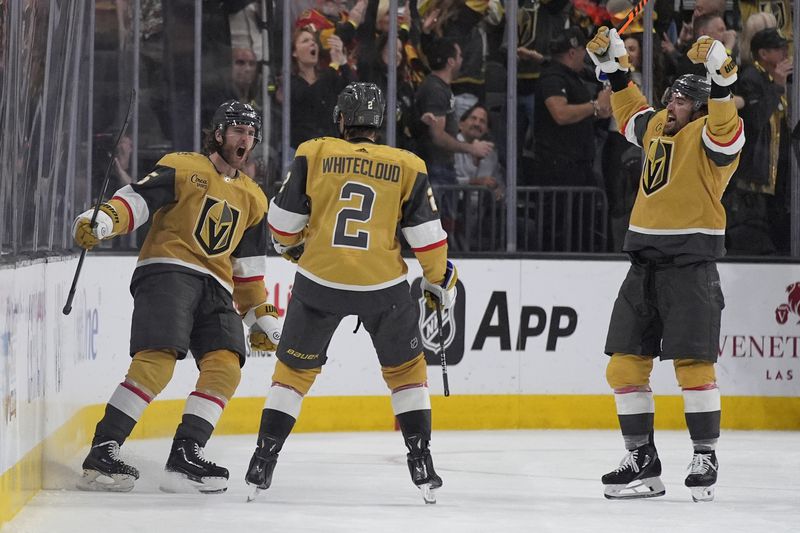Vegas Golden Knights defenseman Noah Hanifin, left, celebrates after scoring against the Dallas Stars during the third period in Game 6 of an NHL hockey Stanley Cup first-round playoff series Friday, May 3, 2024, in Las Vegas. (AP Photo/John Locher)