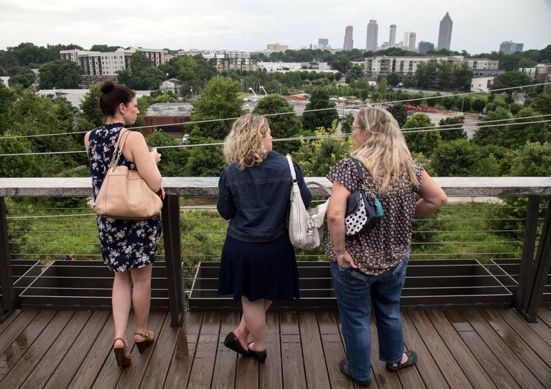 Loren Haley (from left), Paula Keldorph and Karen Jessien enjoy the view and a beer on the rooftop bar at the New Realm Brewing restaurant in Atlanta last week. CONTRIBUTED BY STEVE SCHAEFER