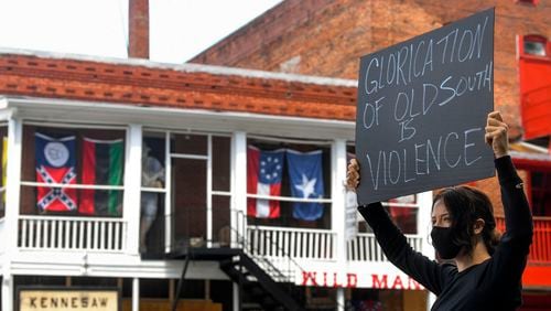 Chelsea Shag demonstrates across the street from a Confederate-era memorabilia shop, during a protest held Friday, June 5, 2020, in Kennesaw. Protests around the nation are occuring to sound off against the killing of George Floyd in Minneapolis police custody. JOHN AMIS FOR THE ATLANTA JOURNAL-CONSTITUTION