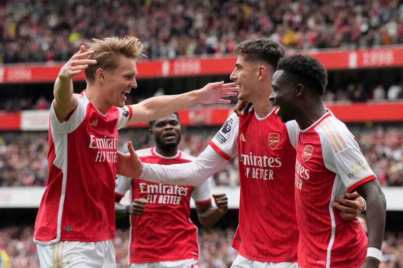 Arsenal's Bukayo Saka, right, celebrates with teammates after scoring his side's opening goal during the English Premier League soccer match between Arsenal and Bournemouth at Emirates Stadium in London, England, Saturday, May 4, 2024. (AP Photo/Frank Augstein)