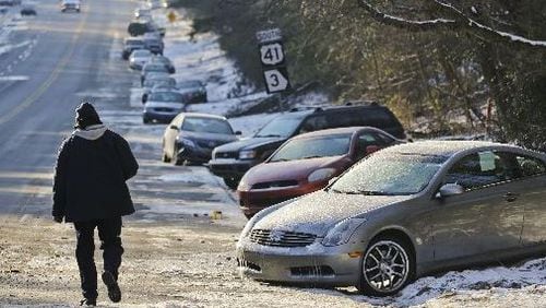 Abandoned cars sit idle along Northside Parkway in Atlanta Jan. 30, 2014. State agencies used four-wheel-drive vehicles to take motorists back to their vehicles from two metro Atlanta locations to retrieve what the GSP numbered at nearly 2000 abandoned vehicles. (AJC File Photo JOHN SPINK/JSPINK@AJC.COM)