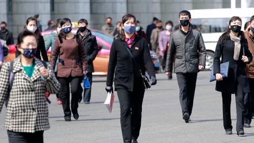 FILE - Pedestrians wear face masks to help prevent the spread of the new coronavirus in Pyongyang, North Korea, on April 1, 2020. North Korea is putting surveillance cameras in schools and workplaces, and collecting fingerprints, photographs and other biometric information from its citizens in a technology-driven push to monitor its population even more closely, a report said Tuesday, April 16, 2024. (AP Photo/Cha Song Ho, File)