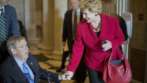 U.S. Sen. Debbie Stabenow, D-Mich., stops in April to greet U.S. Sen. Johnny Isakson, R-Ga., as they leave the Senate chamber on Capitol Hill in Washington after the GOP majority led a change to the Senate rules and lowered the vote threshold for Supreme Court nominees from 60 votes to a simple majority in order to advance Neil Gorsuch to a confirmation vote. Isakson was recovering from back surgery. (AP Photo/Pablo Martinez Monsivais)