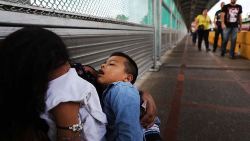A Honduran woman and her child wait along the border after being denied entry into Brownsville, Texas. More 2,300 immigrant children were separated from their parents as part of the Trump administration’s “zero-tolerance” border policy before President Donald Trump signed an executive order to keep immigrant families together in detention. (Photo by Spencer Platt/Getty Images)