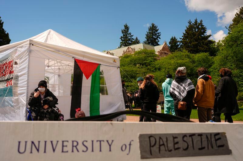 A sign is shown written over to read "University of Palestine" at a pro-Palestinian encampment on the University of Washington campus Monday, April 29, 2024, in Seattle. The group is demanding that the university divest from Israel and cut ties with Boeing, which manufactures products used by Israel Defense Forces. (AP Photo/Lindsey Wasson)