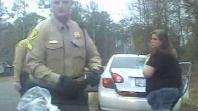 Dasha Fincher, right, looks on during a Dec. 31, 2016, traffic stop as Monroe County deputies search her car. She would spend 3 months in jail as a result of a drug analysis test that incorrectly signaled a bag of cotton canday was meth. (Provided dashcam photo)