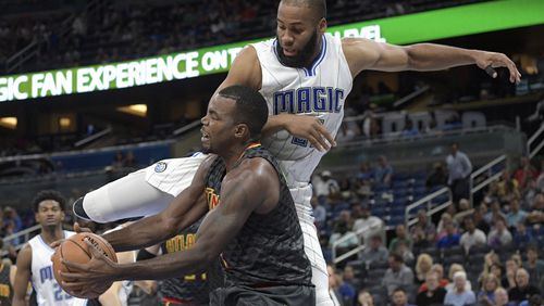 Hawks forward Paul Millsap, front, is fouled by Magic center Arinze Onuaku while going up to shoot during the first half of an NBA preseason basketball game in Orlando, Fla., Sunday, Oct. 16, 2016. (AP Photo/Phelan M. Ebenhack)