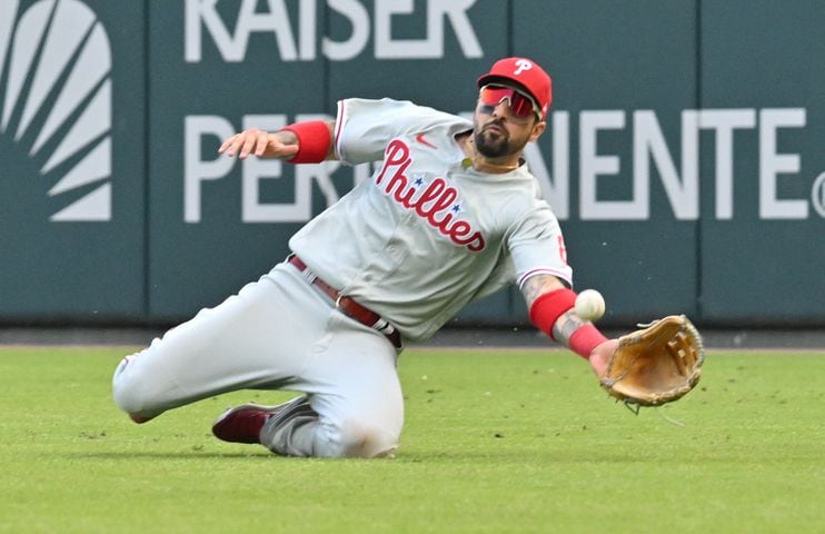 Phillies' Nick Castellanos makes a diving catch of William Contreras' line drive during the ninth inning of game one of the baseball playoff series between the Braves and the Phillies at Truist Park in Atlanta on Tuesday, October 11, 2022. (Hyosub Shin / Hyosub.Shin@ajc.com)