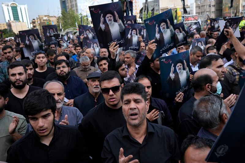 People hold up posters of Iranian President Ebrahim Raisi during a mourning ceremony for him at Vali-e-Asr square in downtown Tehran, Iran, Monday, May 20, 2024. President Raisi and the country's foreign minister were found dead Monday hours after their helicopter crashed in fog, leaving the Islamic Republic without two key leaders as extraordinary tensions grip the wider Middle East. (AP Photo/Vahid Salemi)