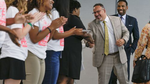 U.S. Secretary of Education Miguel Cardona, followed by Atlanta Mayor Andre Dickens, is greeted by Atlanta school Superintendent Lisa Herring and students in the Atlanta Teen Leaders Academy at the Martin Luther King Jr. Recreation and Aquatic Center on Tuesday, June 21, 2022. Cardona and Dickens touted progress for girls in sports due to the passage of the federal Title IX law in 1972 but said more must be done. (Natrice Miller / natrice.miller@ajc.com)