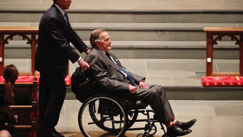 HOUSTON, TX - APRIL 21:  Former President George H.W. Bush, assisted by his son, former President George W. Bush, enter the church during the funeral for former First Lady Barbara Bush on April 21, 2018 in Houston, Texas. (Photo by Brett Coomer - Pool/Getty Images)