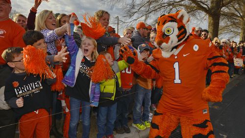 The Clemson "Tiger" mascot warms up the fans as they wait for the team to arrive, Tuesday, Jan. 10, 2017, in Clemson, S.C., the day after the Tigers defeated Alabama 35-31 in the College Football Playoff championship NCAA college football game in Tampa, Fla. (AP Photo/Richard Shiro)