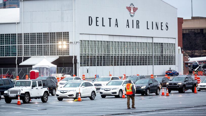 Cars line up at the Delta Air Museum when it was one of the four mass COVID-19 vaccination sites, Monday morning, February 22, 2021.   STEVE SCHAEFER FOR THE ATLANTA JOURNAL-CONSTITUTION