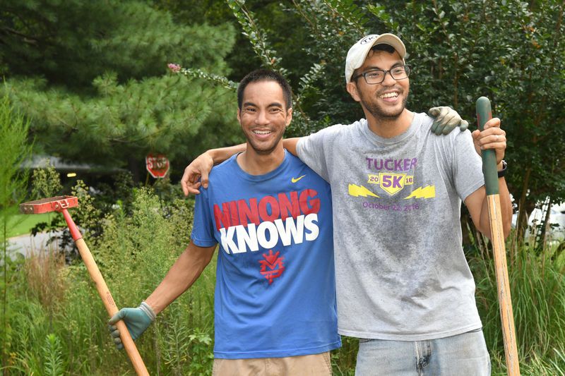 Reggie Ramos (left) and his twin brother, Roger Ramos, (right) lease lawns in the Tucker area and turn them into for-profit mini-farms. (Rebecca Breyer)