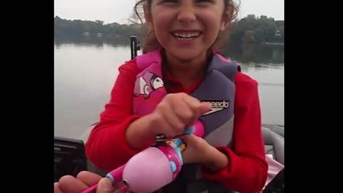 Adorable little girl catches enormous bass on Barbie fishing pole