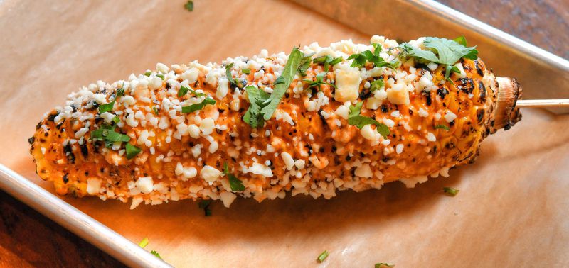 Grilled Street Corn with chipotle mayo, cotija cheese and cilantro. CONTRIBUTED BY CHRIS HUNT PHOTOGRAPHY