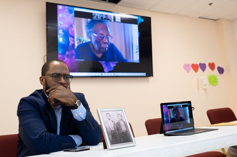Pastor Sabin Strickland listens as Dorothy Pemberton, 95, speaks via video call to a gathering of family at Pleasant Hill Church in Roswell in February. Pemberton says she vividly remembers her grandmother’s retelling of the violence of 1912. (Ben Gray for The Atlanta Journal-Constitution)