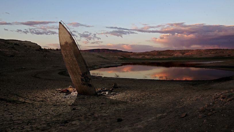 A boat that sank in Lake Mead resurfaces as water continues to recede in the nation's largest reservoir. The lake bed is littered with years of accumulated detritus that has been exposed as water levels have dropped to 30 percent of capacity and continue to fall after almost two decades of severe drought conditions in the American West. Lake Mead is fed by the Colorado River and millions of people rely on the reservoir for water supplies. (Luis Sinco/Los Angeles Times/TNS)